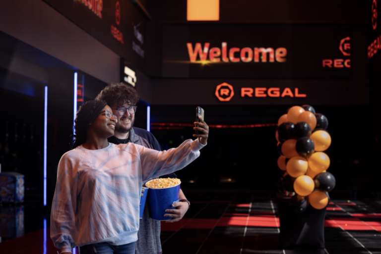 Young couple of friends taking selfie at Regal Theater