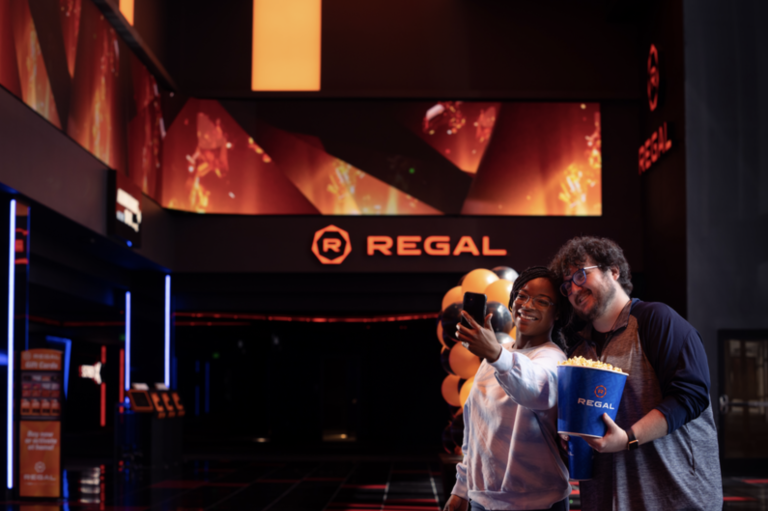 Young couple of friends taking selfie at Regal Movie Theater