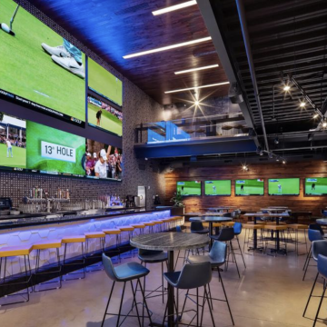 Topgolf Chicago - Modern restaurant and bar area in Topgolf event space. 