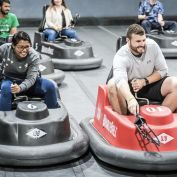 WhirlyBall Chicago - Event attendees laughing and playing the bumper car-inspired game.